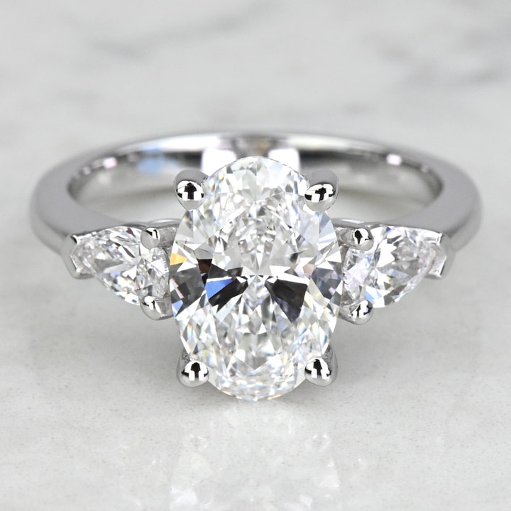 the-allure-of-the-oval-diamond-with-pear-side-stones-a-symphony-of-elegance-and-brilliance
