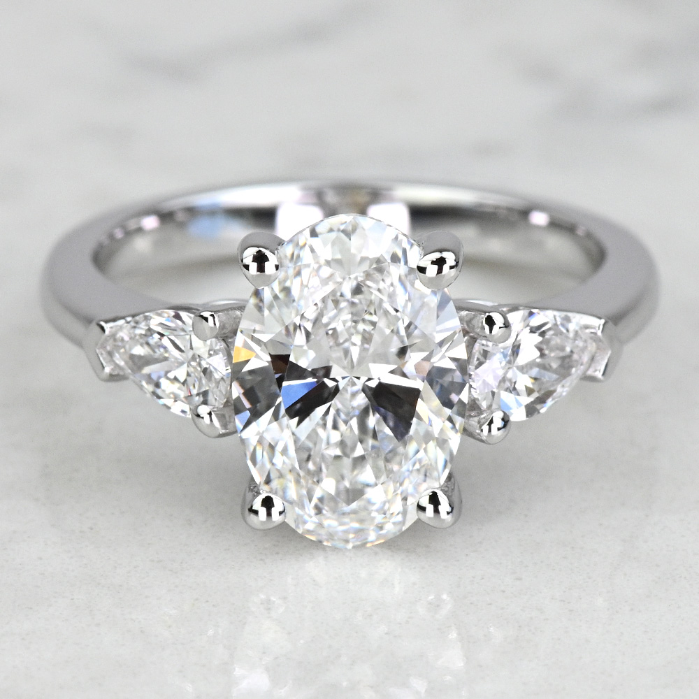 the-perfect-trilogy-unveiling-the-enduring-elegance-of-oval-diamonds-with-pear-side-stones